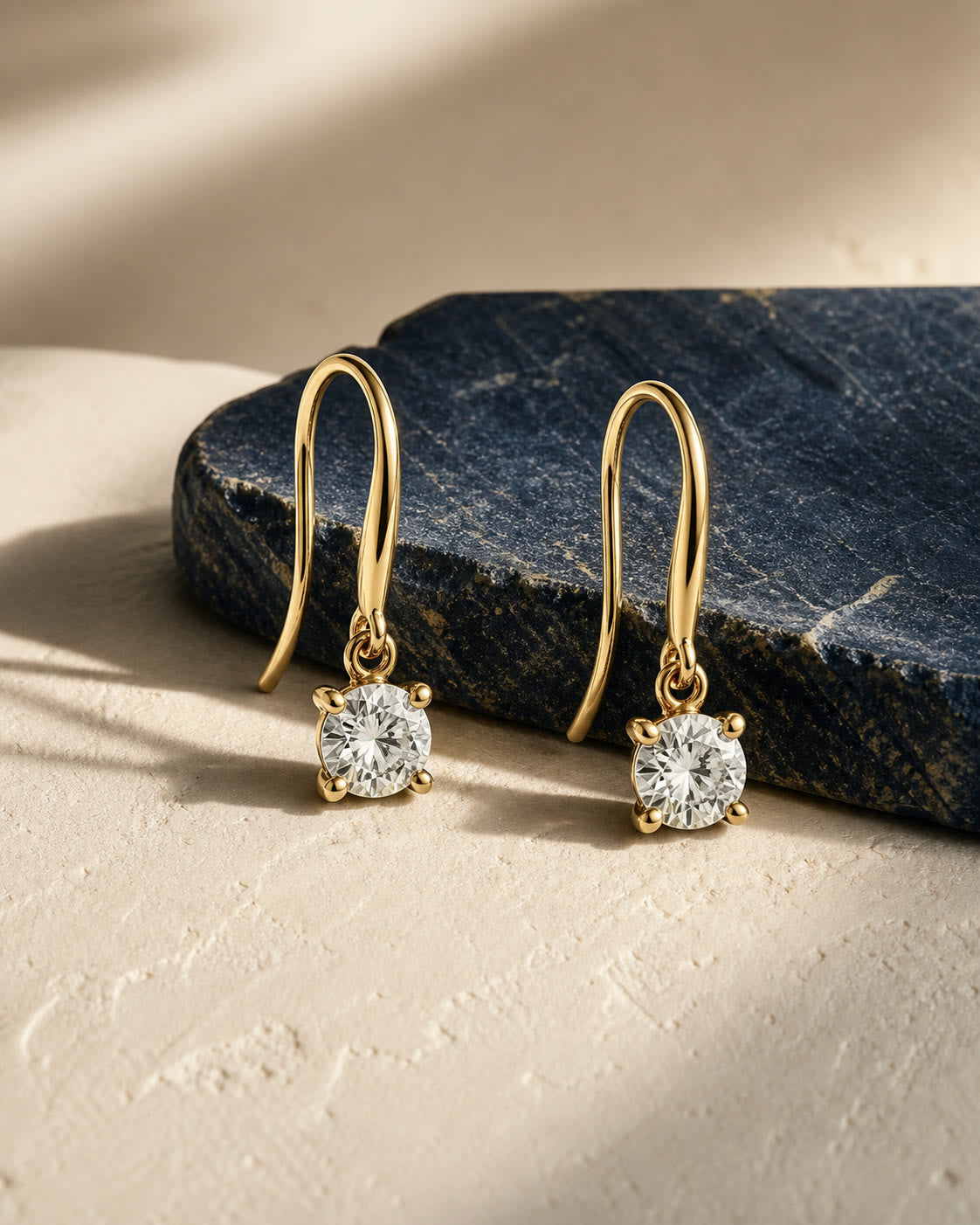 An editorial arrangement of yellow-gold earrings