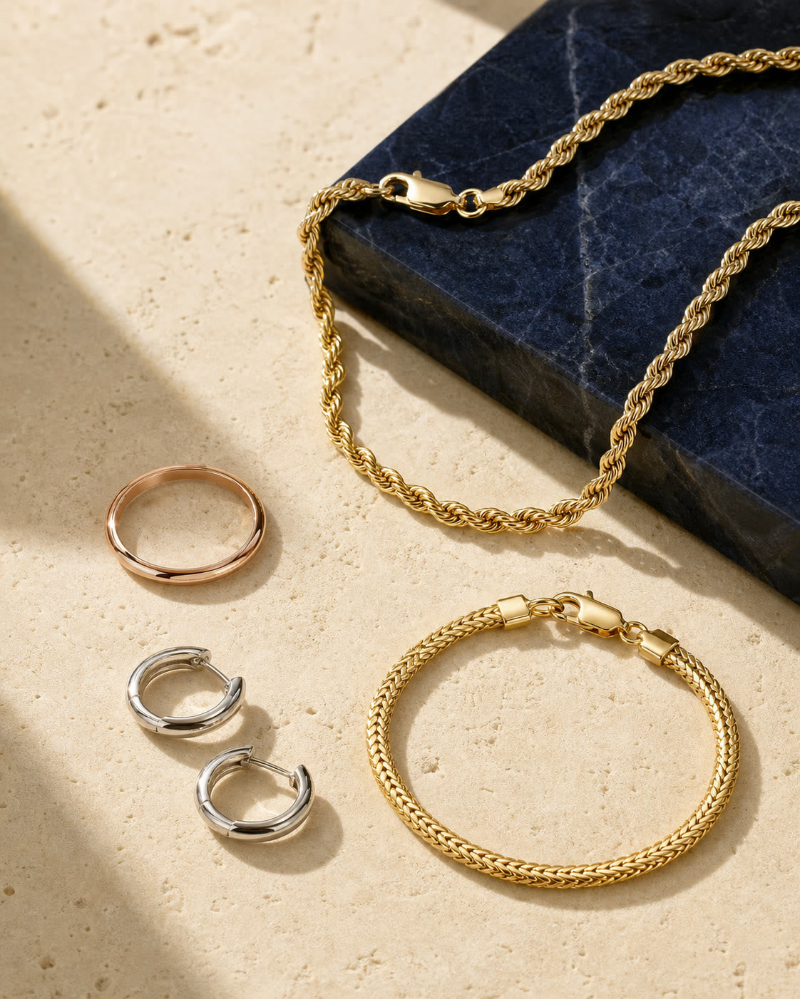 An editorial arrangement of polished gold jewelry
