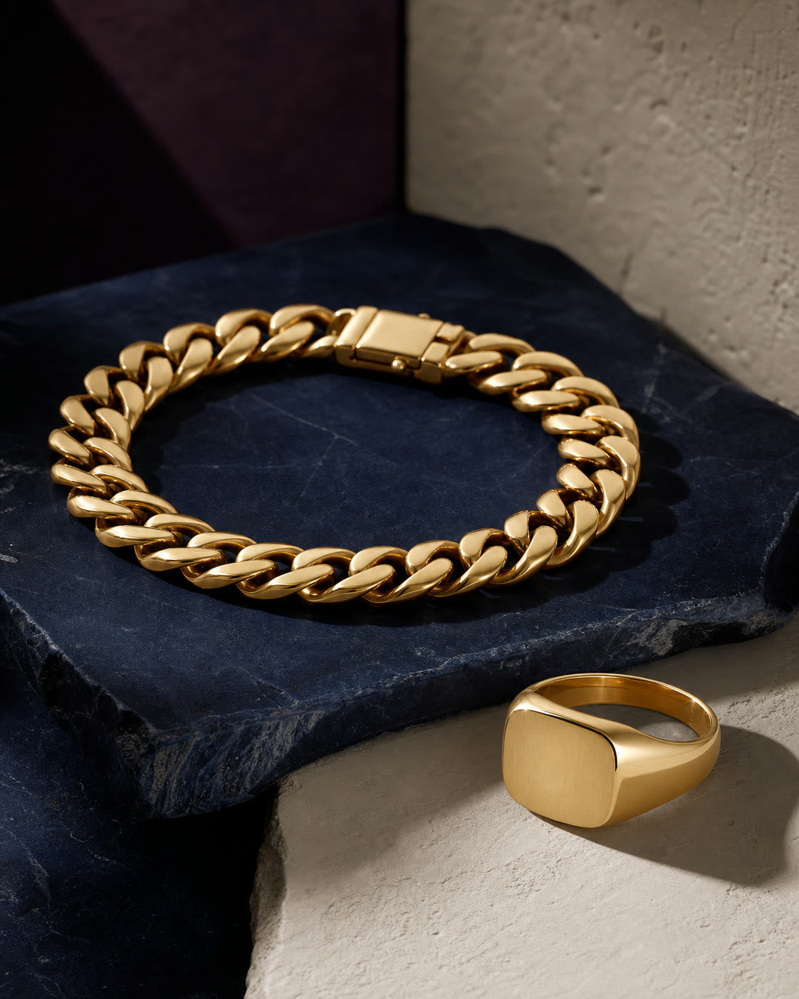 An editorial arrangement of men's yellow-gold jewelry