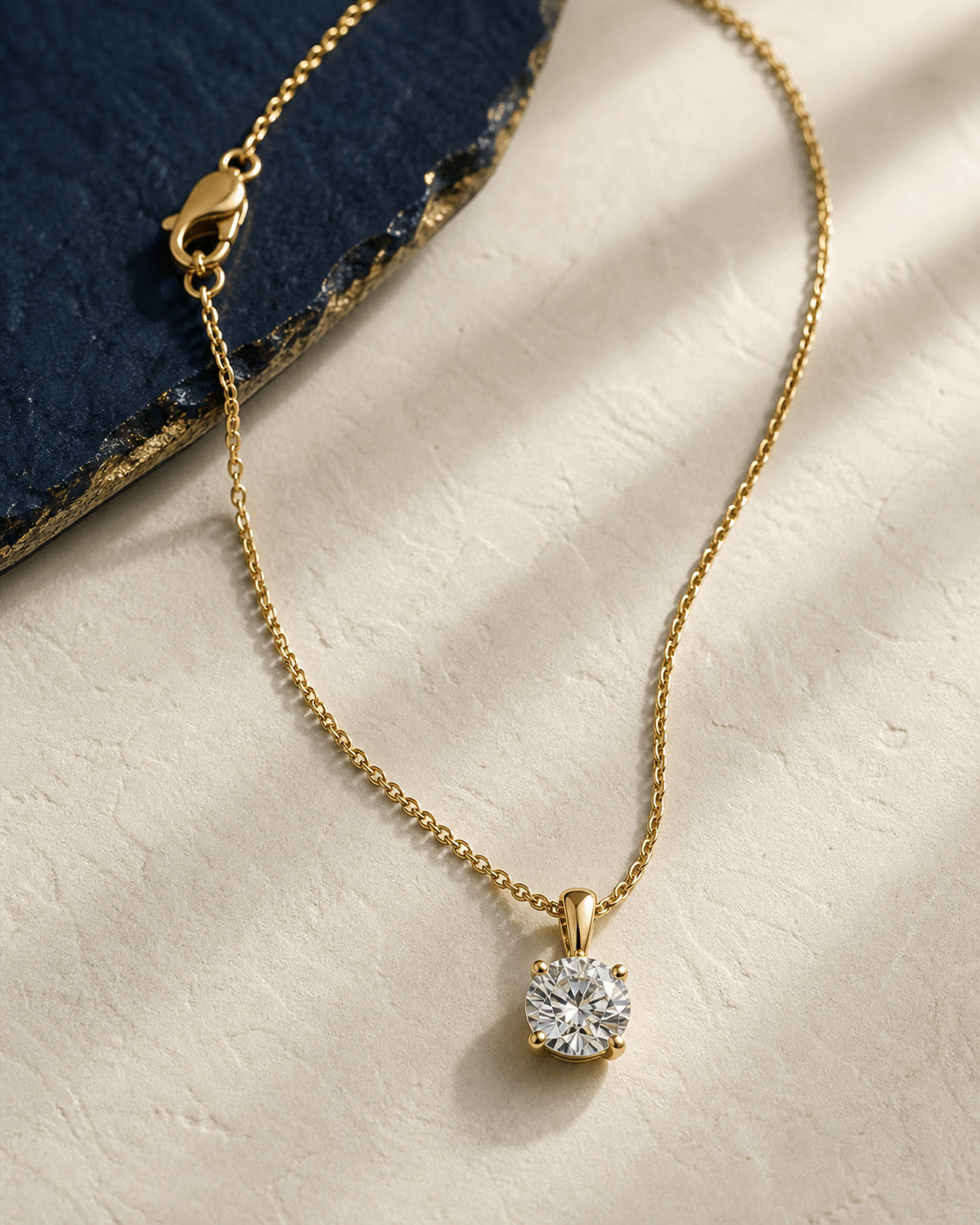 An editorial arrangement of yellow-gold necklaces and pendants