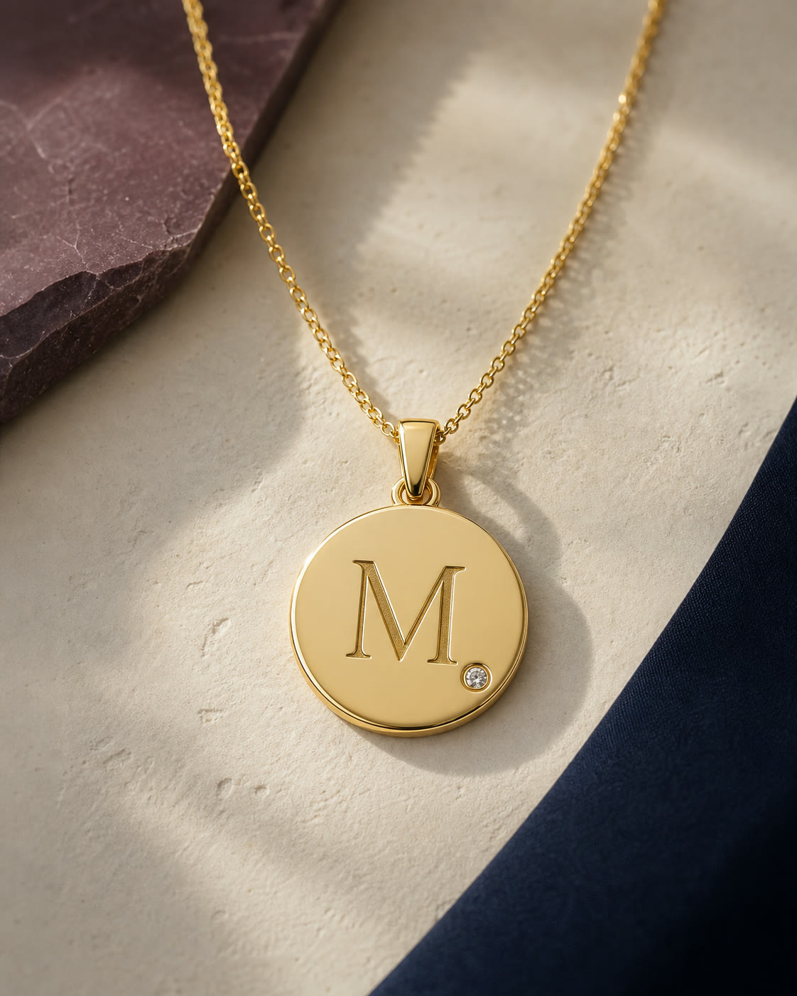 An editorial arrangement of personalized yellow-gold jewelry