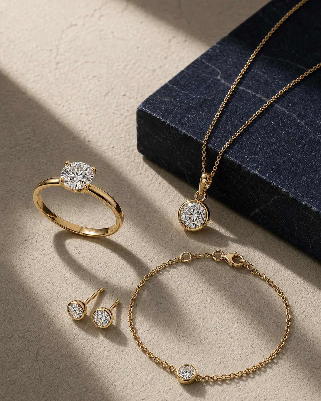 An editorial arrangement of yellow-gold rings, necklaces, earrings, and bracelets